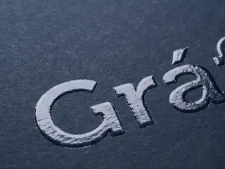 Ilustração de papel escuro com a palavra Gráfica em verniz localizado.